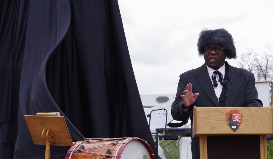 A Frederick Douglass impersonator recites the speech that the famed abolitionist delivered almost 200 years ago at the same site in Lincoln Park on Capitol Hill, where today stands a statue dedicated to the emancipation of the slaves. The National Park organized a recreation of the ceremony in honor of Emancipation Day on Monday. (Julia Airey/The Washington Times)