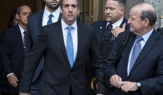Michael Cohen, President Donald Trump&#x27;s personal attorney, center, leaves federal court following a hearing Monday, April 16, 2018, in New York. (AP Photo/Craig Ruttle)