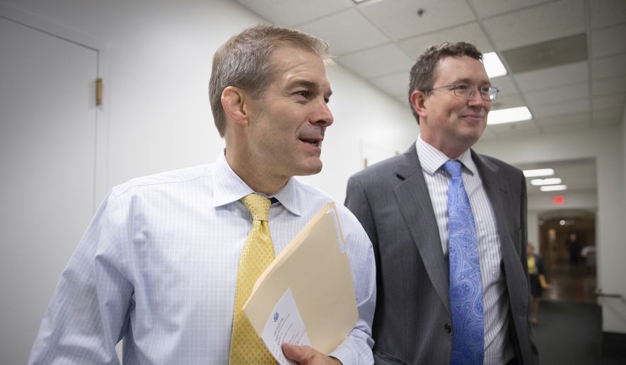 In this photo taken Tuesday, Nov. 17, 2015, Rep. Jim Jordan, R-Ohio, left, and Rep. Thomas Massie, R-Ky., both members of the conservative House Freedom Caucus, GOP strategy session at the Capitol in Washington. (AP Photo/J. Scott Applewhite)