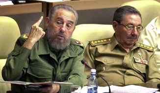 In this Nov. 2, 2002 file photo, then-Cuban President Fidel Castro, left, seated next to his brother Defense Minister Raul Castro and first vice president, speaks during the inauguration of the ninth session of the National Assembly, in Havana, Cuba. Fidel’s commitment to socialism never wavered. (AP Photo/Cristobal Herrera, File)