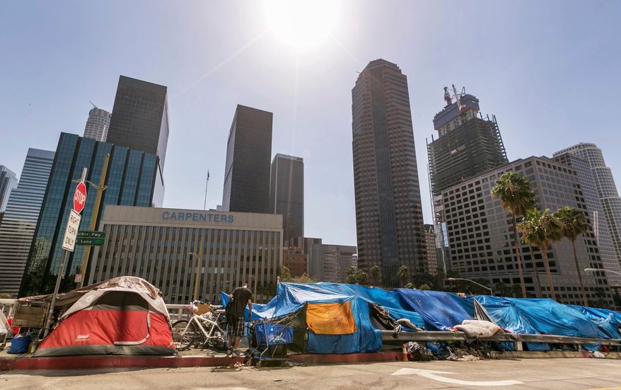 This Sept. 22, 2015 file photo shows tents used by the homeless lining a downtown Los Angeles street. (AP Photo/Damian Dovarganes, File) **FILE**