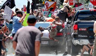 In this Aug. 12, 2017, photo by Ryan Kelly of The Daily Progress, people fly into the air as a car drives into a group of protesters demonstrating against a white nationalist rally in Charlottesville, Va. The photo won the 2018 Pulitzer Prize for Breaking News Photography, announced Monday, April 16, 2018, at Columbia University in New York. (Ryan Kelly/The Daily Progress via AP)