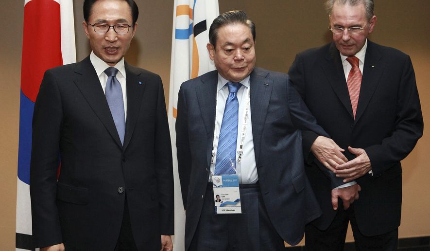 FILE - In this July 5, 2011, file photo, President of the International Olympic Committee (IOC) Jacques Rogge, right, meets with South Korean President Lee Myung-bak, left, and Samsung Chairman Lee Kun-hee, center, in Durban, South Africa, ahead the opening ceremony for the 123rd IOC session that will decide the host city for the 2018 Olympics Winter Games. Samsung has denied a media report it launched illicit lobbying to help bring the 2018 Winter Olympics to Pyeongchang, South Korea. (AP Photo/Rajesh Jantilal-Pool, File)