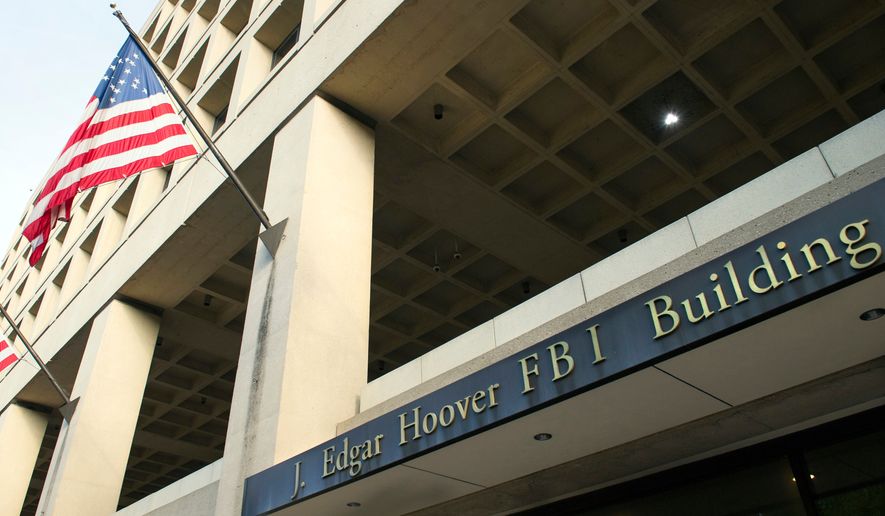 This Nov. 2, 2016, file photo shows the FBI's J. Edgar Hoover headquarter building in Washington. (AP Photo/Cliff Owen, File)