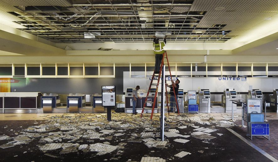 All flights were canceled at the Colorado Springs Airport in Colorado Springs, Colo., after a late night fire Monday, April 16, 2018. The United check-in area received heavy damage from water and falling ceiling tiles. Crews were working hard to fix damaged areas of the terminal on Tuesday, in hopes the terminal could reopen as soon as possible. (Jerilee Bennett/The Gazette via AP)