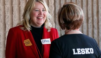 Arizona State Rep. and U.S. Representative candidate Debbie Lesko speaks with a constituent during the meeting of the state committee of the Arizona Republican Party in Phoenix. The sprawling suburbs west of Phoenix may put a brake on Democratic optimism following surprising special election wins in places like Alabama, Pennsylvania and other GOP strongholds. (AP Photo/Matt York, File)