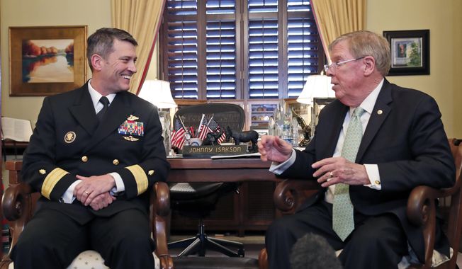 U.S. Navy Rear Adm. Ronny Jackson, M.D., left, sits with Sen. Johnny Isakson, R-Ga., chairman of the Veteran&#x27;s Affairs Committee, before their meeting on Capitol Hill, Monday, April 16, 2018 in Washington. Jackson is President Donald Trump&#x27;s nominee to be the next Secretary of Veterans Affairs. (AP Photo/Alex Brandon)