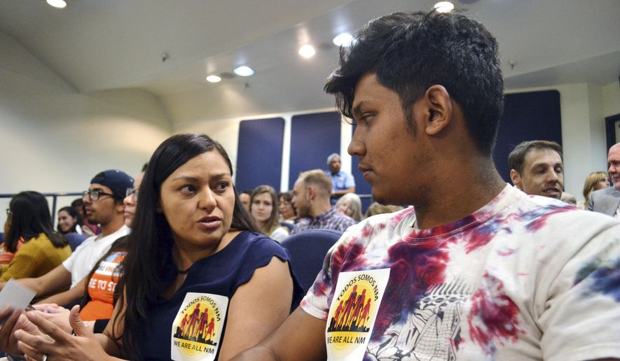 Nora Hernandez, left, of the immigrant advocacy group New Mexico Dream Team, speaks with Javier Solis, a local high school senior, ahead of a City Council meeting on whether to bolster immigrant friendly policies in Albuquerque, New Mexico, on Monday, April 17, 2018. The Albuquerque City Council voted to enact immigrant friendly policies at the meeting, including one that that would bar federal immigration agents from prisoner transport centers without a warrant, and another that would prevent city workers from asking about people&#39;s immigration status. (AP Photo/Mary Hudetz)