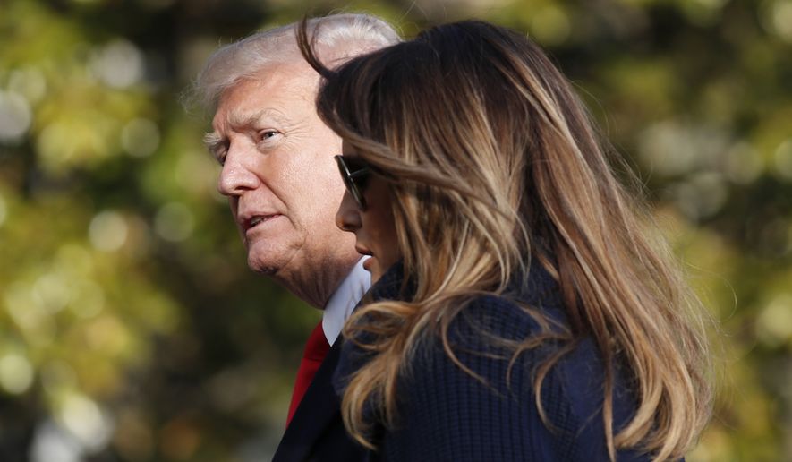 In this March 19, 2018, photo, President Donald Trump, accompanied by first lady Melania Trump, walks on the South Lawn of the White House in Washington, on his return from a trip to New Hampshire. Former Playboy model Karen McDougal apologized to Melania Trump for a 10-month affair she claims she had with President Trump that started with him offering her money after the first time they had sex. (AP Photo/Alex Brandon)