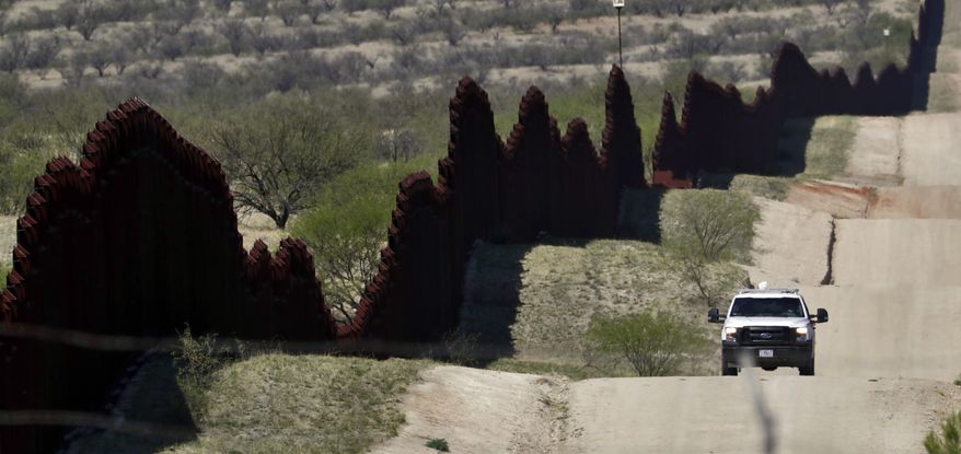 A Customs and Border Patrol agent patrols the international border Tuesday, April 10, 2018 near Nogales, Ariz. The Republican governors of Texas, Arizona and New Mexico on Monday committed 1,600 Guard members to the border, giving President Donald Trump many of the troops he requested to fight what he's called a crisis of migrant crossings and crime. (AP Photo/Matt York)