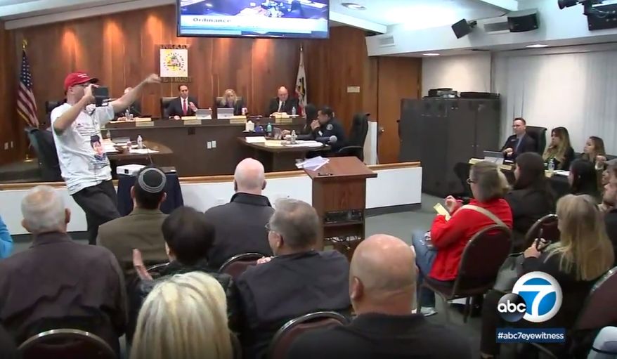 In this Monday, March 19, 2018 image made from video provided by KABC-7, council members listen during a meeting in Los Alamitos, Calif. Leaders of the small California city of 12,000 people voted this week to exempt it from California's sanctuary law, a state law that limits cooperation between local police and federal immigration agents. Residents are suing the tiny Southern California city following a vote by elected officials to exempt the community from a state law limiting police collaboration with immigration authorities. (KABC-7 via AP)