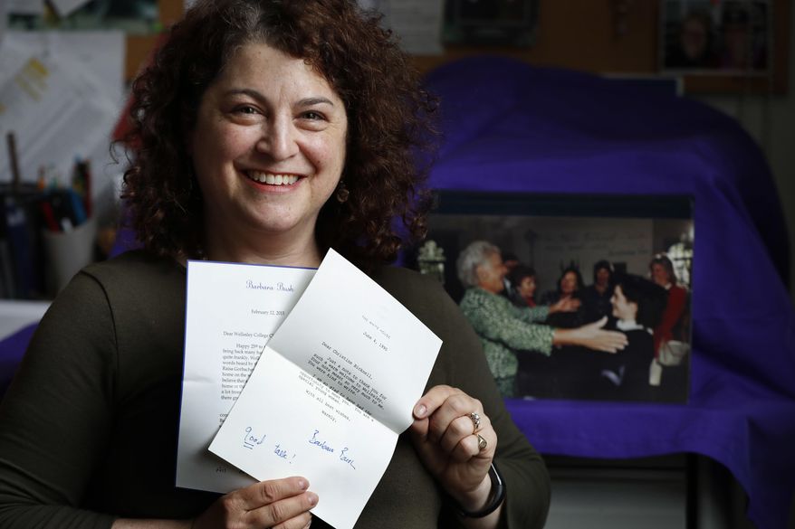 Chris Bicknell Marden holds personal letters she received from former first lady Barbara Bush, Wednesday, April 18, 2018, in Waterville, Maine. Marden and Bush developed a longtime friendship starting in 1990 when Bush gave the commencement address at Wellesley College. Marden was the student commencement speaker that year. The photo in background shows Bush reaching out to hug Marden at her graduation. (AP Photo/Robert F. Bukaty)