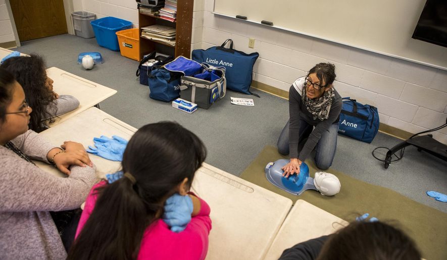 In this March 15, 2018, photo, Nancy Bockino, a backcountry-safety instructor, leads a CPR demonstration Jackson Hole Middle School in Jackson, Wyo. (Amber Baesler/Jackson Hole News & Guide via AP)