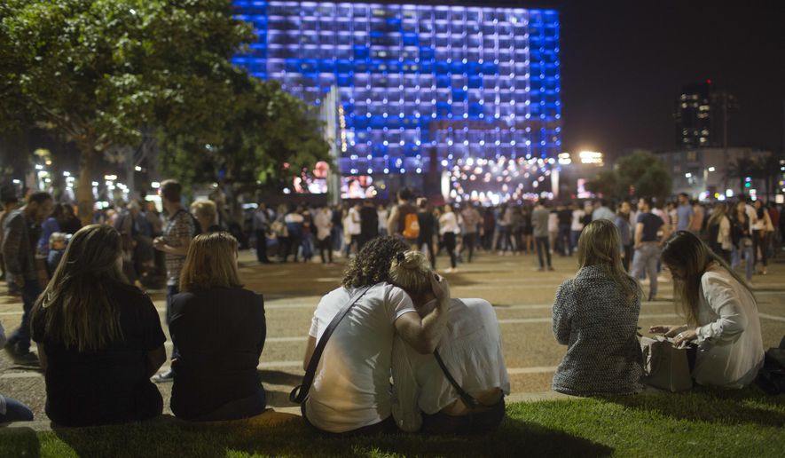 Israelis attend a ceremony marking Israel&#x27;s annual Memorial Day for fallen soldiers, in Tel Aviv, Israel, Tuesday, April 17, 2018. Israel marks the annual Memorial Day in remembrance of soldiers who died in the nation&#x27;s conflicts, beginning at dusk Tuesday until Wednesday evening. (AP Photo/Oded Balilty)