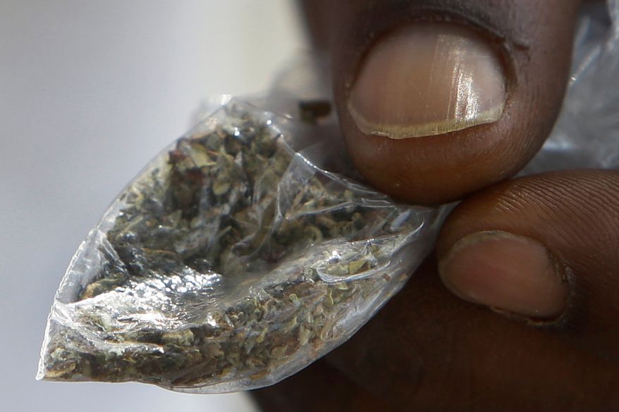 A man holds a bag of synthetic marijuana in Houston. In a report released Tuesday, April 10, 2018, fake marijuana likely contaminated with rat poison has killed three people in Illinois and sickened more than 100 others in the past month. (Melissa Phillip/Houston Chronicle via AP)