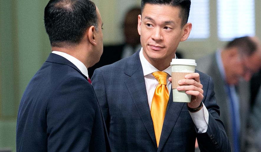 FILE--In this Sept. 13, 2017, file ph too, California Assemblyman Ash Kalra, D-San Jose, left, talks with fellow Democratic Assemblyman Evan Low, of Campbell, at the Capitol in Sacramento, Calif. Low says he authored a bill Thursday, April 19, 2018, to crack down on people selling conversion therapy as a way to change someone's sexual orientation because conversion therapy has been proven ineffective and harmful. (AP Photo/Rich Pedroncelli, file)