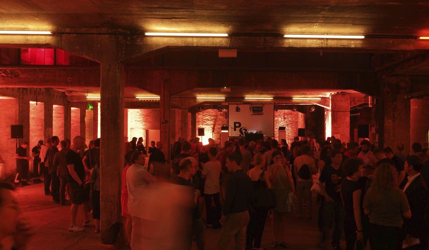 FILE - In this Aug. 26, 2015 file photo guests attend the opening of the 'Pop-Kultur' festival in the Berghain club in Berlin. A local lawmaker in Berlin has reaped ridicule online for her proposal to close one of the city’s internationally renowned techno clubs because of the partygoers’ drug consumption, long opening hours and lascivious behavior on the dance floor. (Jeers Carstensen/dpa via AP, file)