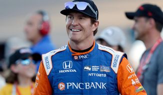 FILE - In this Saturday, April 7, 2018, file photo, driver Scott Dixon smiles before the IndyCar auto race at Phoenix International Raceway in Avondale, Ariz. Dixon will be the latest IndyCar driver to enter the realm of reality TV when he auditions in Indianapolis next week for &amp;quot;American Ninja Warrior. (AP Photo/Rick Scuteri, File)