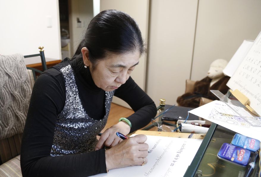 In this March 7, 2018, photo, retired harpist Yumi Makino practices western calligraphy in her apartment room in Tokyo. Makino won a two-year legal battle to get out of a senior citizens home she hated and get her deposit money back in a rare victory over a big real estate company. Her experience reflects the challenges many older Japanese face in finding suitable care and accommodations in “super-aging” Japan, the world’s No. 1 aging nation. (AP Photo/Yuri Kageyama)
