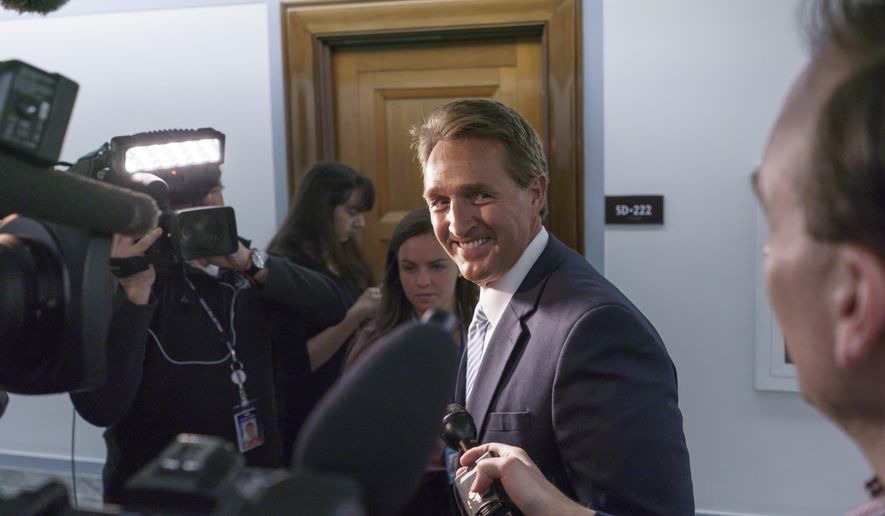 Sen. Jeff Flake, R-Ariz., is questioned by reporters about changing his vote to yes on President Trump&#x27;s nomination of Oklahoma congressman James Bridenstine to run NASA, on Capitol Hill in Washington, Thursday, April 19, 2018. (AP Photo/J. Scott Applewhite)