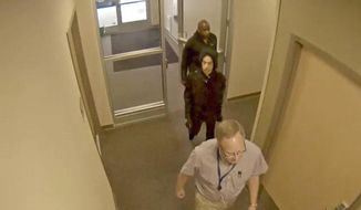 In this image made from surveillance video provided Thursday, April 19, 2018, by the Carver County Sheriff&#39;s Office, as part of an investigative file into Prince&#39;s death, the superstar, center, enters a clinic of Dr. Michael Todd Schulenberg on April 20, 2016, the day before he was found dead of an accidental fentanyl overdose. The doctor is not facing criminal charges and his attorney says he had no role in Prince&#39;s death. (Carver County Sheriff&#39;s Office via AP)