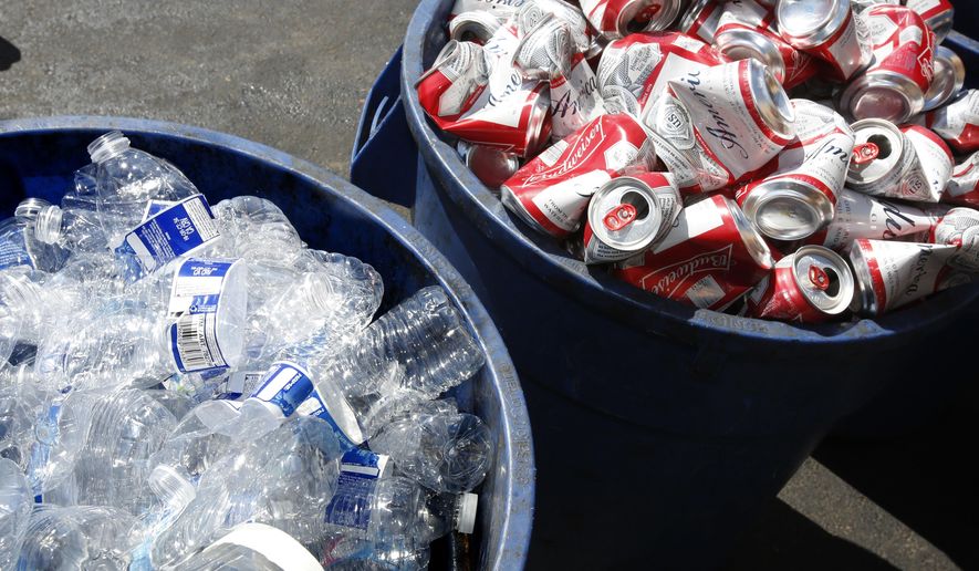 FILE -In this July 5, 2016 file photo, cans and plastic bottles brought in for recycling are seen at a recycling center in Sacramento, Calif. California has charged five people with defrauding the state's recycling program out of $80.3 million dollars--the largest alleged fraud scheme in the program's history, officials said Thursday, April 19, 2018. (AP Photo/Rich Pedroncelli, File)