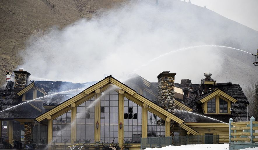 Firefighters work to extinguish a blaze that heavily damaged the Warm Springs Lodge Thursday, April 19, 2018, after a fire broke out late Wednesday at the famed lodge at the base of one of the nation&#x27;s premier ski destinations in Sun Valley, Idaho. There were no immediate reports of injuries, no damage estimate and no immediate word on the cause. The lodge closed for the season last Sunday and was not open to the public when the fire started. (Jason Kindred/Idaho Mountain Express via AP)