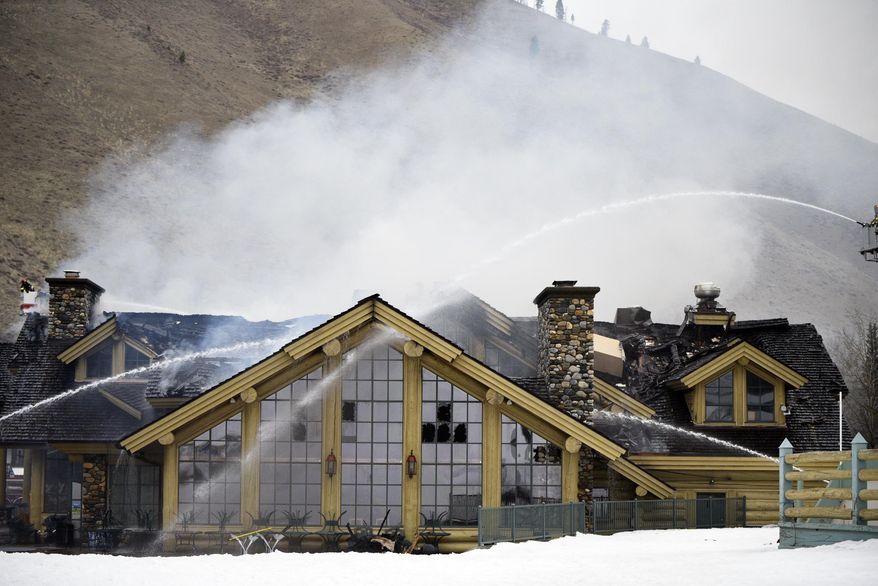 Firefighters work to extinguish a blaze that heavily damaged the Warm Springs Lodge Thursday, April 19, 2018, after a fire broke out late Wednesday at the famed lodge at the base of one of the nation's premier ski destinations in Sun Valley, Idaho. There were no immediate reports of injuries, no damage estimate and no immediate word on the cause. The lodge closed for the season last Sunday and was not open to the public when the fire started. (Jason Kindred/Idaho Mountain Express via AP)