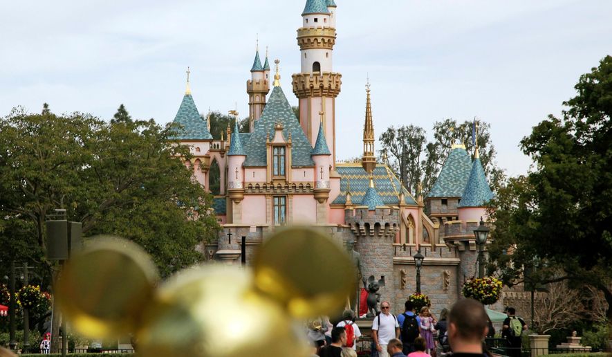 FILE - In this Jan. 22, 2015 file photo, visitors walk toward Sleeping Beauty's Castle at Disneyland Resort in Anaheim, Calif. Authorities say thieves made off with 8,000 Disneyland tickets when they stole a box trailer from a youth agricultural education organization. The California Highway Patrol says the trailer is owned by Future Farmers of America and was stolen Wednesday, April 18, 2018, from the group's office in the city of Galt, south of Sacramento. (AP Photo/Jae C. Hong, File)