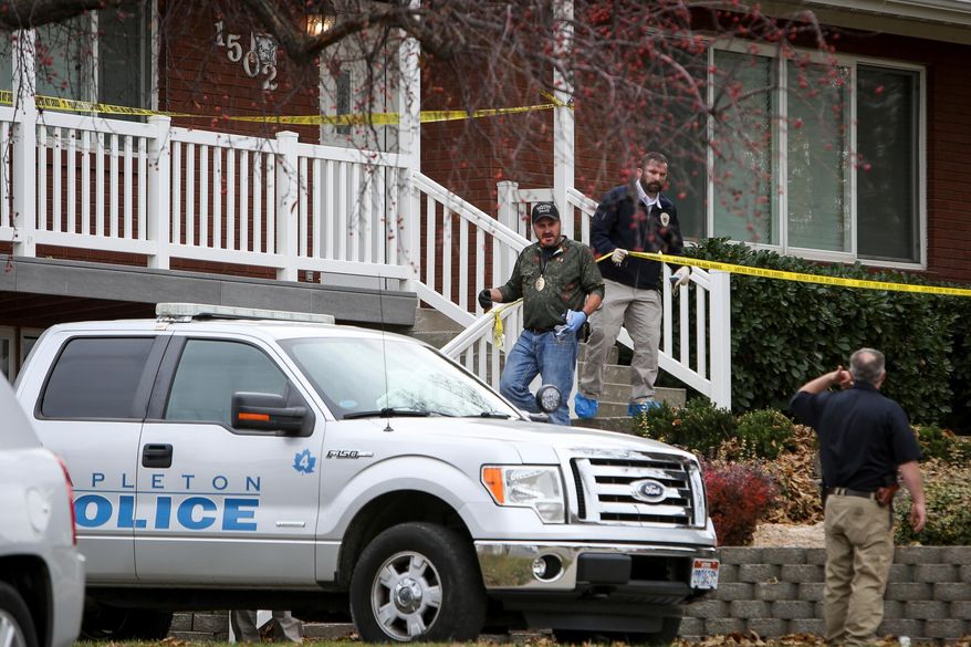 FILE - In this Nov. 10, 2017, file photo, members of the Mapleton Police Department and forensics gather evidence at a home in Mapleton, Utah. Police documents say a couple who recently moved from Switzerland to Utah planned together a murder-suicide that left their family of four dead, including buying sleeping pills and researching shootings. (Adam Fondren/The Deseret News via AP, File)
