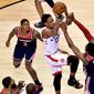 Toronto Raptors guard DeMar DeRozan (10) drives to the basket as Washington Wizards guard John Wall (2) defends and guard Bradley Beal (3) watches during the second half of Game 2 of an NBA basketball first-round playoff series Tuesday, April 17, 2018, in Toronto. (Frank Gunn/The Canadian Press via AP) **FILE**