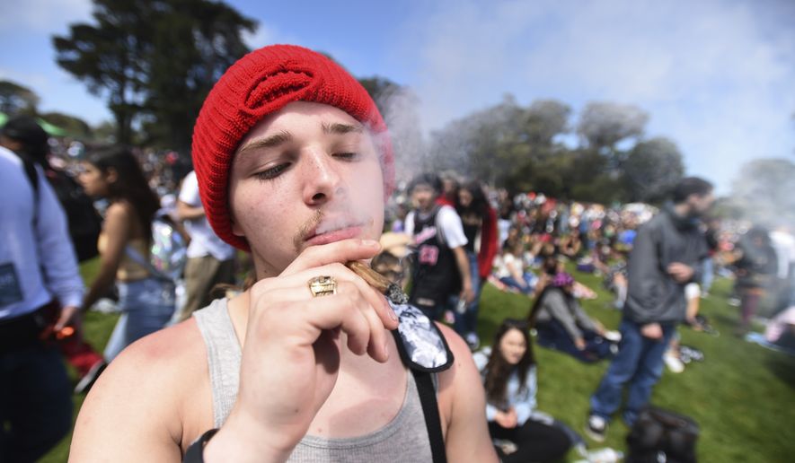 A man who declined to give his name smokes a joint on Hippie Hill in San Francisco, Friday, April 20, 2018. Thousands of people flocked to Hippie Hill for the annual 420 celebration of all things pot and the number that is stoners&#39; code for smoking marijuana. Events also were held in other cities worldwide. (AP Photo/Josh Edelson)