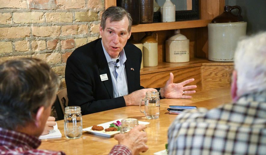 In this Jan. 11, 2018, photo, businessman Doug Robinson speaks with members of the public at a meet and greet at the Glenwood Canyon Brew Pub in Glenwood Springs, Colo. Robinson, a nephew of former Massachusetts governor Mitt Romney, failed to collect enough signatures to get on the Republican gubernatorial primary ballot. (Chelsea Self/Glenwood Springs Post Independent via AP)