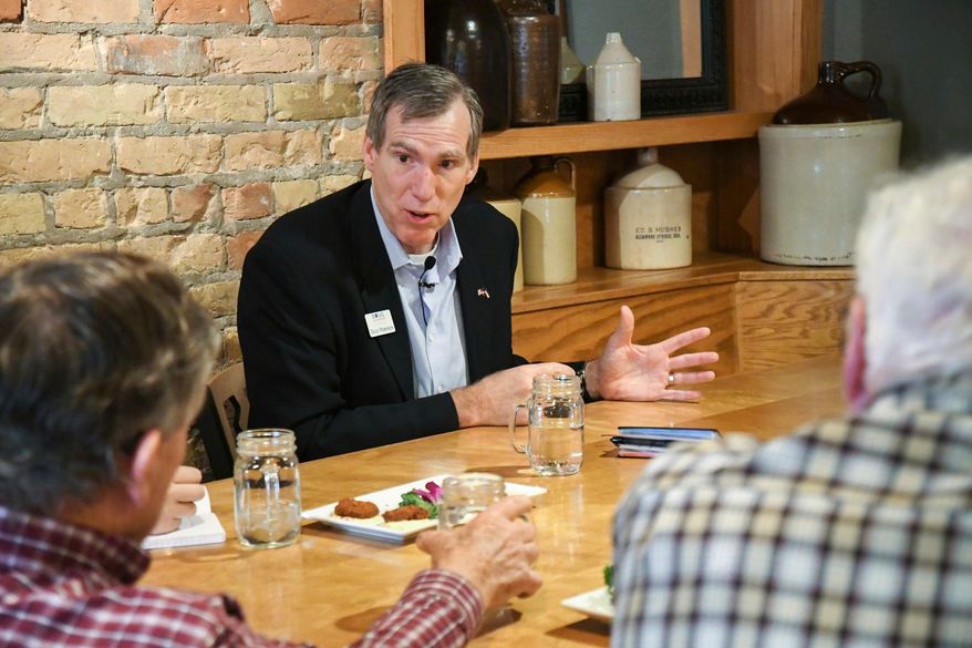 In this Jan. 11, 2018, photo, businessman Doug Robinson speaks with members of the public at a meet and greet at the Glenwood Canyon Brew Pub in Glenwood Springs, Colo. Robinson, a nephew of former Massachusetts governor Mitt Romney, failed to collect enough signatures to get on the Republican gubernatorial primary ballot. (Chelsea Self/Glenwood Springs Post Independent via AP)