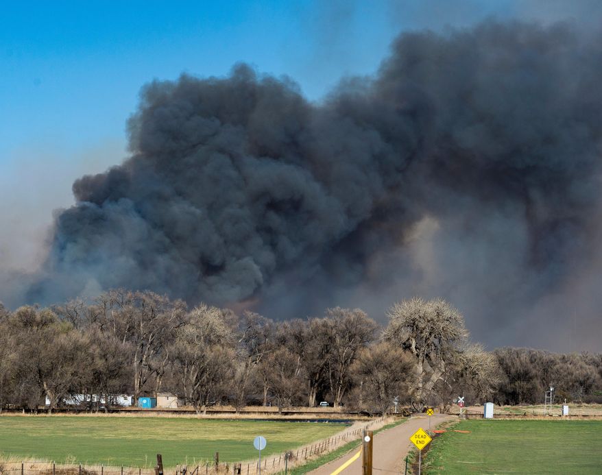 FILE - In this April 17, 2018 file photo, wildfires burn in rural southern El Paso County near Hanover, Colo. As Colorado enters a drought-fueled wildfire season, rural fire departments are bracing for another round of budget cuts triggered by the state constitution. Fire chiefs are pushing lawmakers to pass a late bill that would delay them.(Dougal Brownlie/The Gazette via AP, File)