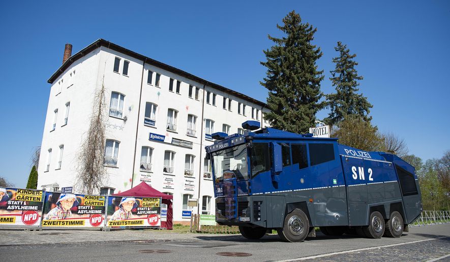 A water canon stands in front of the hotel Neisseblick in Ostritz, Germany Friday, April 20, 2018. A court has banned the consumption of alcohol at a planned neo-Nazi concert in eastern Germany to prevent an outbreak of violence. The weekend festival in the town of Ostritz is expected to attract up to 1,000 far-right extremists from Germany, the neighboring Czech Republic and Poland. (Pawel Sosnowski/dpa via AP)