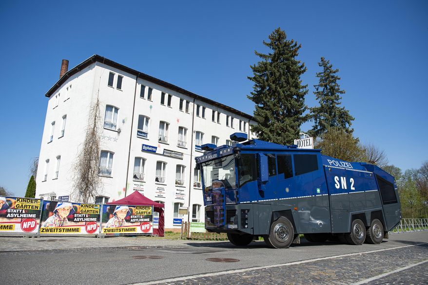 A water canon stands in front of the hotel Neisseblick in Ostritz, Germany Friday, April 20, 2018. A court has banned the consumption of alcohol at a planned neo-Nazi concert in eastern Germany to prevent an outbreak of violence. The weekend festival in the town of Ostritz is expected to attract up to 1,000 far-right extremists from Germany, the neighboring Czech Republic and Poland. (Pawel Sosnowski/dpa via AP)