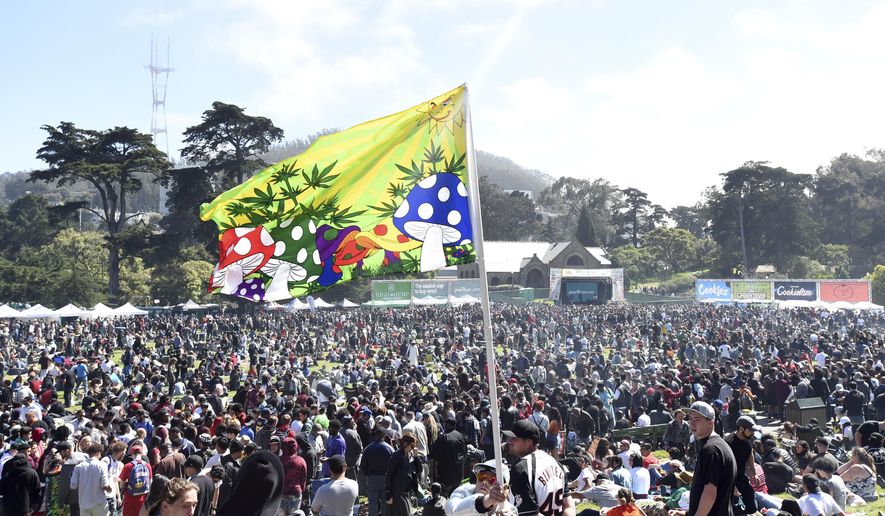 A mushroom flag blows in the wind as thousands gather in San Francisco, Calif., on Friday, April 20, 2018. (AP Photo/Josh Edelson)