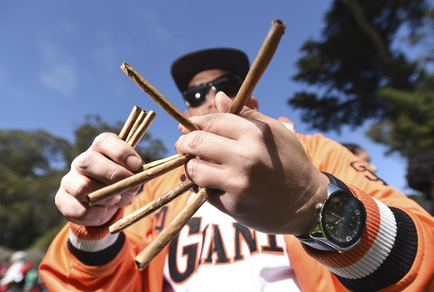 A man who only gave his name as Art sells blunts for $5 a piece in San Francisco, Calif., on Friday, April 20, 2018. Thousands of marijuana enthusiasts flocked to San Francisco’s Golden Gate Park for the annual April 20 celebration of cannabis that culminated with the crowd sparking up precisely at 4:20 p.m. The gathering was the first since California enacted broad legalization of marijuana Jan. 1. The festival is a celebration of the number 420, stoner’s code for smoking marijuana. A small, informal gathering that began several years ago has blossomed into a full-blown festival of corporate sponsors and commercial booths selling smoking devices, t-shirts and food. (AP Photo/Josh Edelson)