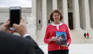 Susette Kelo holds a photo of her little pink house as she is photographed in front of the Supreme Court building in Washington, Tuesday, April 17, 2018. The new movie &amp;quot;Little Pink House,&amp;quot; directed by Courtney Balaker, is based on the story of the eminent domain Supreme Court case between Kelo and the City of New London, Conn.. Kelo lost her home when the Supreme Court ruled 5-4 in June 2005 that local governments may seize homes and businesses, even against the owners&#39; will, for private economic development. (AP Photo/Carolyn Kaster)
