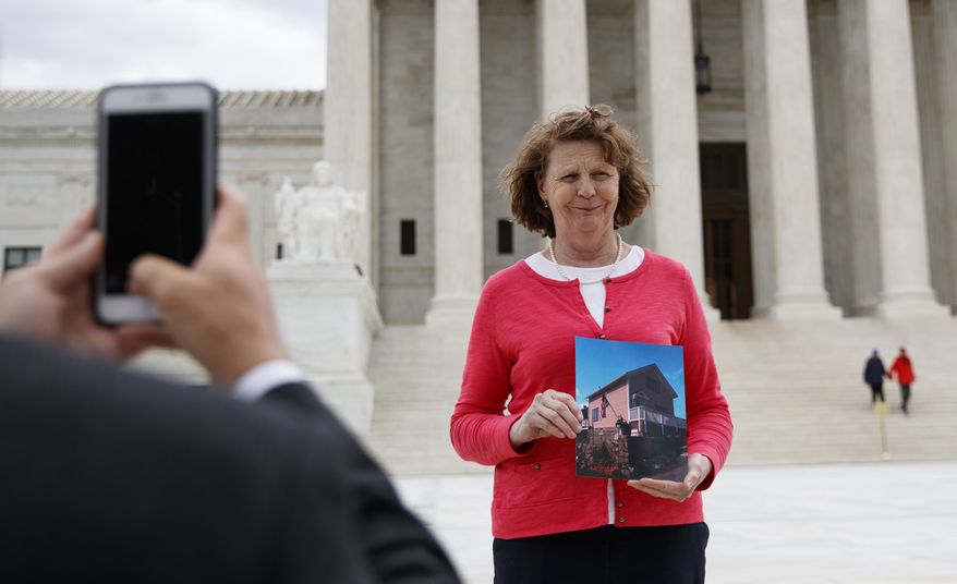 Susette Kelo holds a photo of her little pink house as she is photographed in front of the Supreme Court building in Washington, Tuesday, April 17, 2018. The new movie &amp;quot;Little Pink House,&amp;quot; directed by Courtney Balaker, is based on the story of the eminent domain Supreme Court case between Kelo and the City of New London, Conn.. Kelo lost her home when the Supreme Court ruled 5-4 in June 2005 that local governments may seize homes and businesses, even against the owners&#39; will, for private economic development. (AP Photo/Carolyn Kaster)