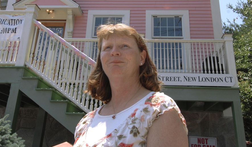 In this June 21, 2008, file photo, Susette Kelo, left, former owner of the controversial little pink house, stands in front of her old home at its new location in New London, Conn. Susette Kelo took on the city of New London, which was trying to take her house through eminent domain. She ultimately lost in a 5-4 decision by the Supreme Court. (AP Photo/Jessica Hill, File)  **FILE**