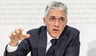 Swiss Federal Public Prosecutor Michael Lauber speaks during a media conference about the Federal Public Prosecutor&#39;s Office&#39;s 2017 activity report, in Bern, Switzerland, on Friday, April 20, 2018. Switzerland’s attorney general has a message to foreign counterparts as his office pores over reams of seized documents and some two-dozen criminal cases linked to FIFA and world football: “Come to us.” Lauber says the investigations require both quick action and patience, and noted “good developments” like how growing cooperation has led to a total of 45 requests for legal assistance from Switzerland with regard to football. (Thomas Hodel/Keystone via AP)
