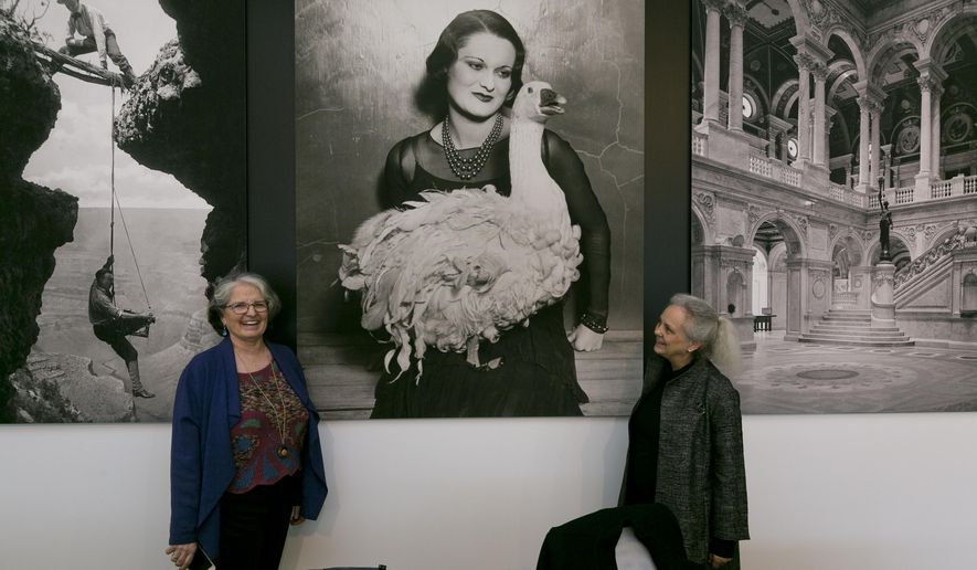 This Thursday, April 19, 2018, photo shows exhibition curator Anne Wilkes Tucker, left, and Library of Congress photo curator Beverly Brannan, right, during a media preview of the exhibit "Not An Ostrich: And Other Images From America's Library," at the Annenberg Space For Photography in Los Angeles. (AP Photo/Damian Dovarganes)