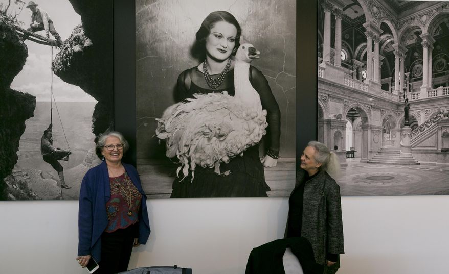 This Thursday, April 19, 2018, photo shows exhibition curator Anne Wilkes Tucker, left, and Library of Congress photo curator Beverly Brannan, right, during a media preview of the exhibit "Not An Ostrich: And Other Images From America's Library," at the Annenberg Space For Photography in Los Angeles. (AP Photo/Damian Dovarganes)
