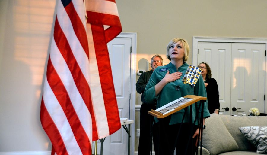 In this Thursday, April 5, 2018 photo, Summer Morris, left, leads the Pledge of Allegiance at the Sarah Polk chapter meeting of the Daughters of the American Revolution on at the Cool Springs Clubhouse in Franklin, Tenn. (Melanie Balakit /The Tennessean via AP)