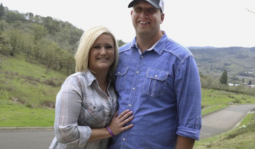 In this April 14, 2018, photo, Jennifer Myers and Brian Boswell pose for a photo at their Roseburg, Ore., home. Myers was born with cystic fibrosis and successfully underwent lung transplant surgery in 2015. (Michael Sullivan/The News-Review via AP)