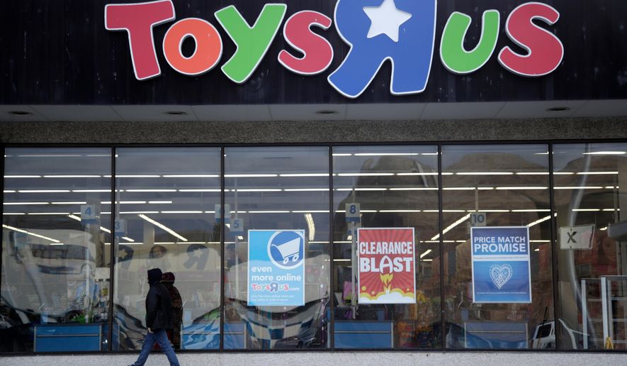 FILE- This Jan. 24, 2018, file photo shows a person walking near the entrance to a Toys R Us store, in Wayne, N.J. Canada’s Fairfax Financial Holding has placed a bid of $300 million to buy Toys R Us’s Canadian operations in bankruptcy. According to court papers filed late Thursday, April 19, 2018, the bidder is taking on a role of a “stalking horse” in a court-approved auction set for Monday in New York. That means it could be outbid in the auction if other buyers come in with a higher offer. The bid from Fairfax surpassed the $215 million offer that Isaac Larian, the CEO of privately held toy company MGA Entertainment, made last week. (AP Photo/Julio Cortez, File)