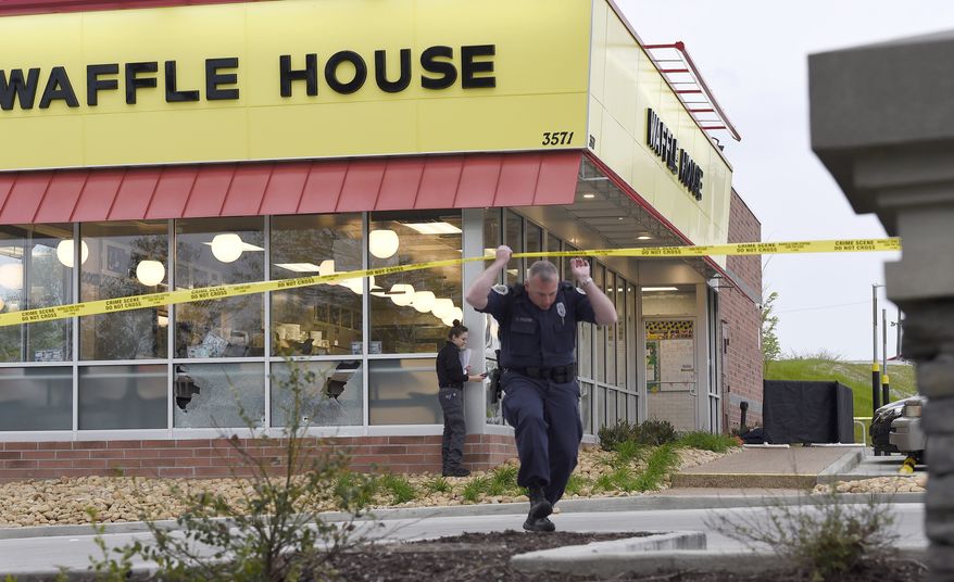 Law enforcement officials work the scene of a fatal shooting at a Waffle House in the Antioch neighborhood of Nashville, Sunday, April 22, 2018. (George Walker IV/The Tennessean via AP)