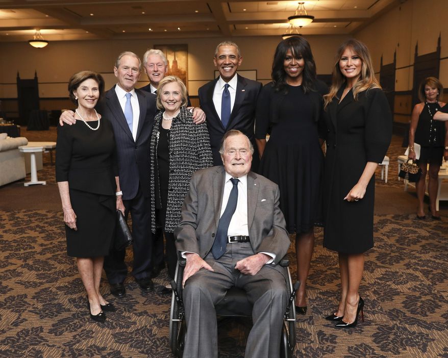 This Saturday, April 21, 2018, photo provided by the Office of former U.S. President George H.W. Bush, shows Bush, front center, and past presidents and first ladies Laura Bush, from left, George W. Bush, Bill Clinton, Hillary Clinton, Barack Obama, Michelle Obama and current first lady Melania Trump in a group photo at the funeral service for former first lady Barbara Bush, in Houston. Barbara Bush died Tuesday, April 17. She was 92. (Paul Morse/Courtesy of Office of George H.W. Bush via AP)